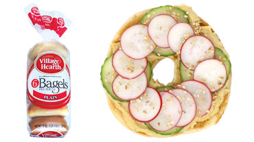 Hummus Cucumbers Radishes and Sesame Seeds on Village Hearth Plain Bagel